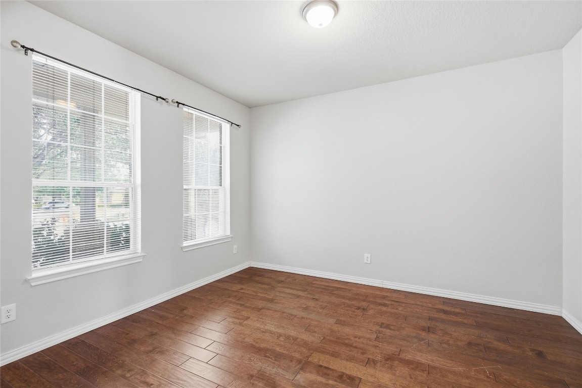 4410 Meadowside Lane Round Rock, TX 78665 - Photo 3 of 22 an empty room with wooden floor and windows