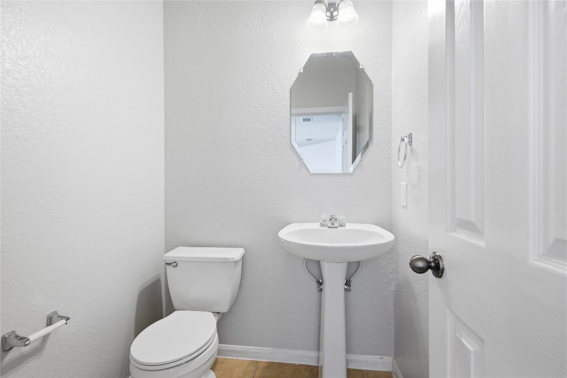 4410 Meadowside Lane Round Rock, TX 78665 - Photo 7 of 22 a bathroom with a toilet sink and mirror