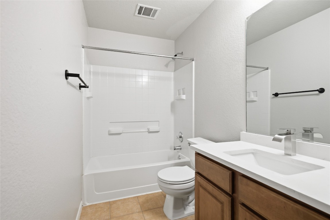 4410 Meadowside Lane Round Rock, TX 78665 - Photo 10 of 22 a bathroom with a sink a toilet and shower