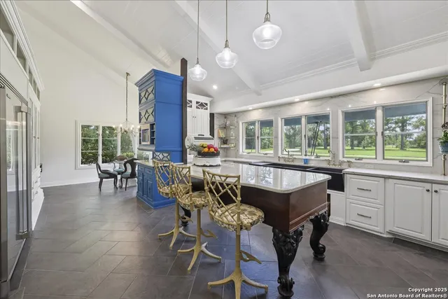 a kitchen with stainless steel appliances granite countertop furniture and a table