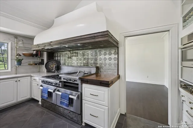 a kitchen with stainless steel appliances granite countertop a stove and a refrigerator