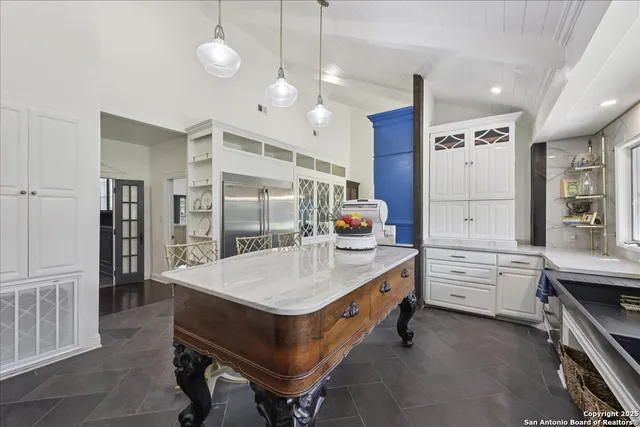 a room with cabinets a sink and a stove