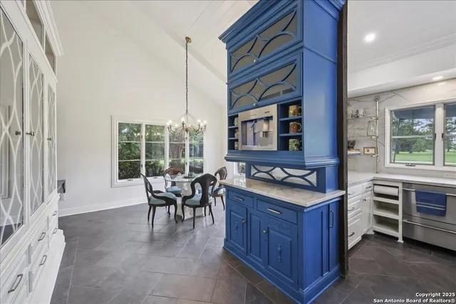 a kitchen with granite countertop a stove and cabinets