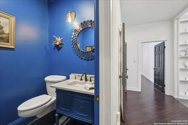 a bathroom with a toilet a sink and mirror