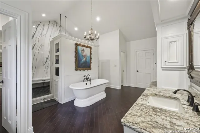 a spacious bathroom with a double vanity sink a mirror and shower