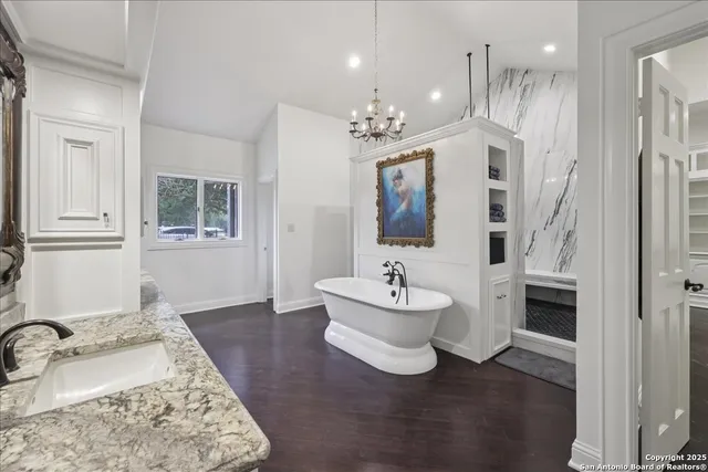a spacious bathroom with a double vanity sink a mirror and a bathtub
