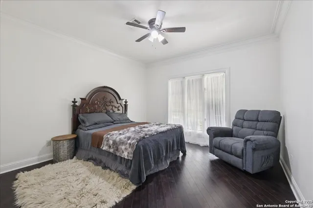 a bedroom with a bed couch and a window