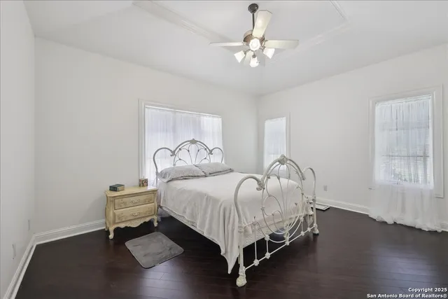 a bedroom with bed and a chandelier