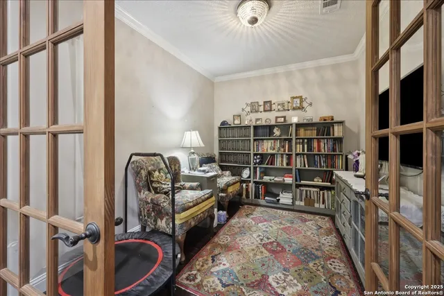 a living room with furniture a rug and a book shelf