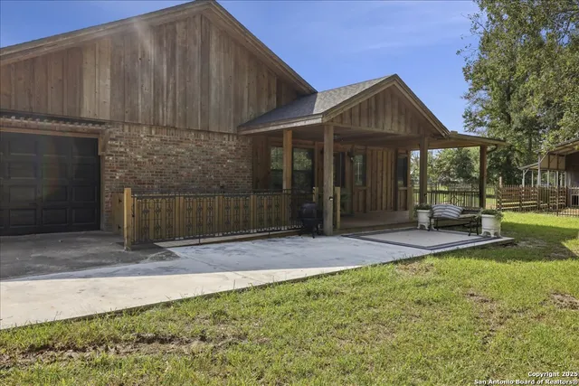 a backyard of a house with table and chairs
