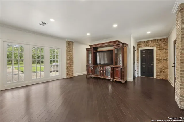 a big room with wooden floor windows and closet