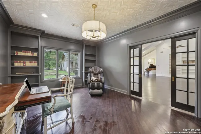 a view of a livingroom with furniture hardwood floor and a large window