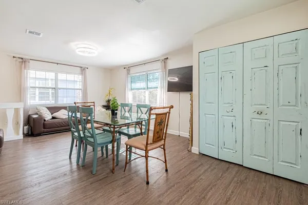 a view of a dining room with furniture and wooden floor
