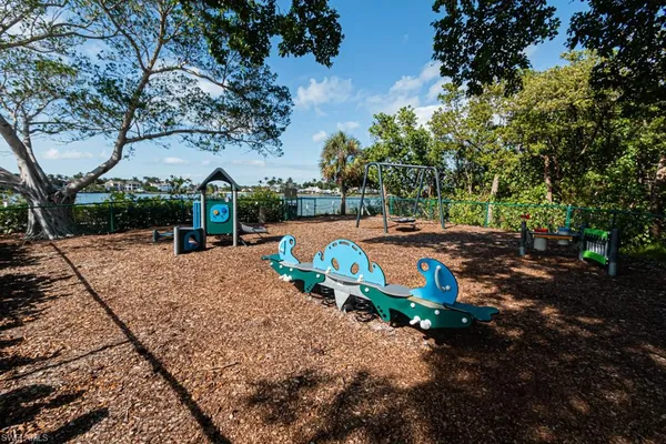 a view of outdoor space with playground and green space