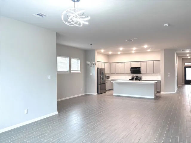 a view of kitchen with refrigerator and microwave