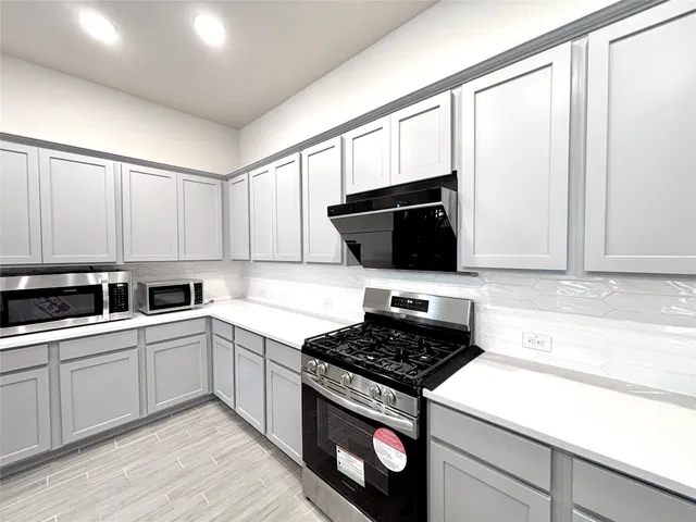 a kitchen with a stove and a microwave