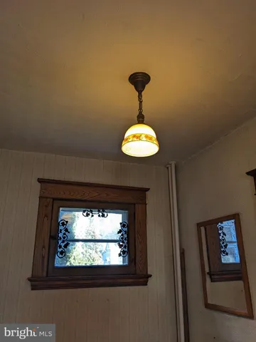 a view of a livingroom with window and chandelier
