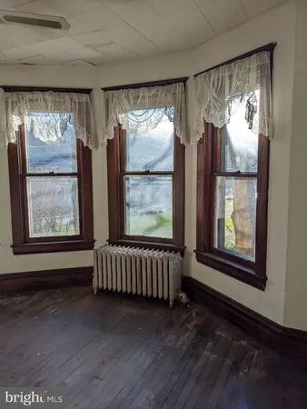 a view of front door with furniture and a window