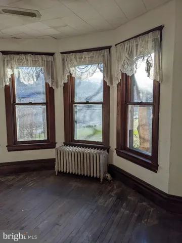 a view of front door with furniture and a window
