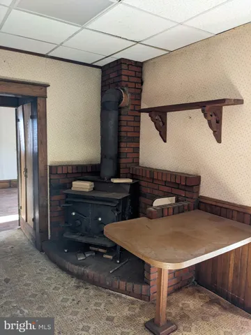 a room with table chairs and windows