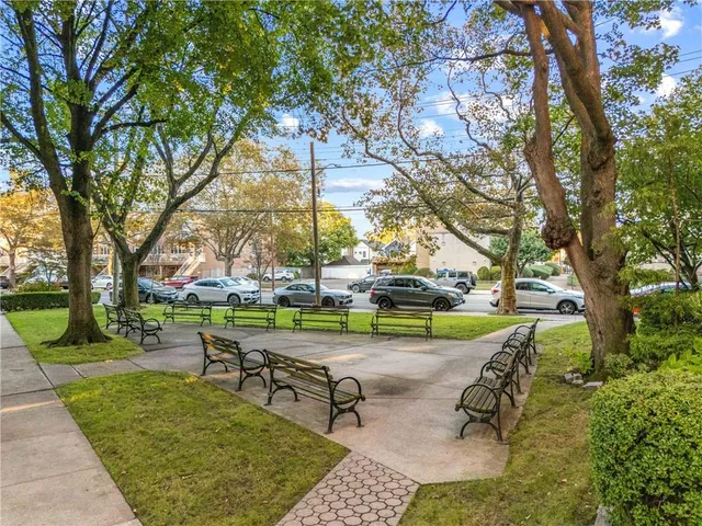 a view of backyard with swimming pool and green space