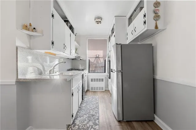 a kitchen with stainless steel appliances granite countertop a refrigerator and a stove