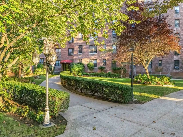 a city view with tall buildings and a yard