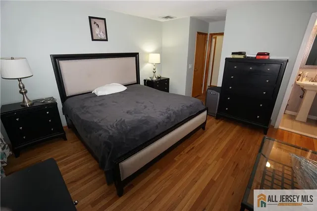 a bedroom with a bed and a night stand