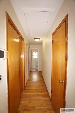 a view of a hallway with wooden floor