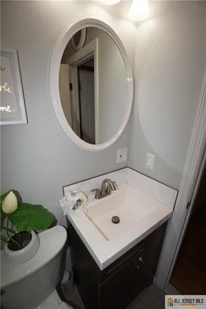 a bathroom with a sink a toilet and a mirror