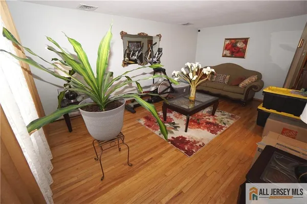 a view of a workspace with furniture and wooden floor