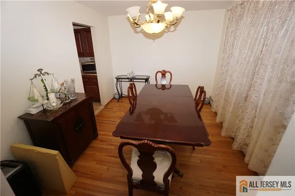 a room with table chairs and wooden floor