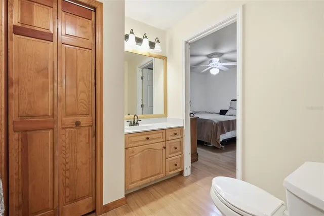a bathroom with a toilet a sink and mirror