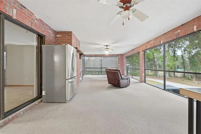 a view of a kitchen with a sink and a refrigerator