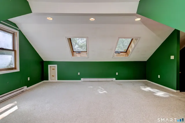 a view of a room with a projector and windows