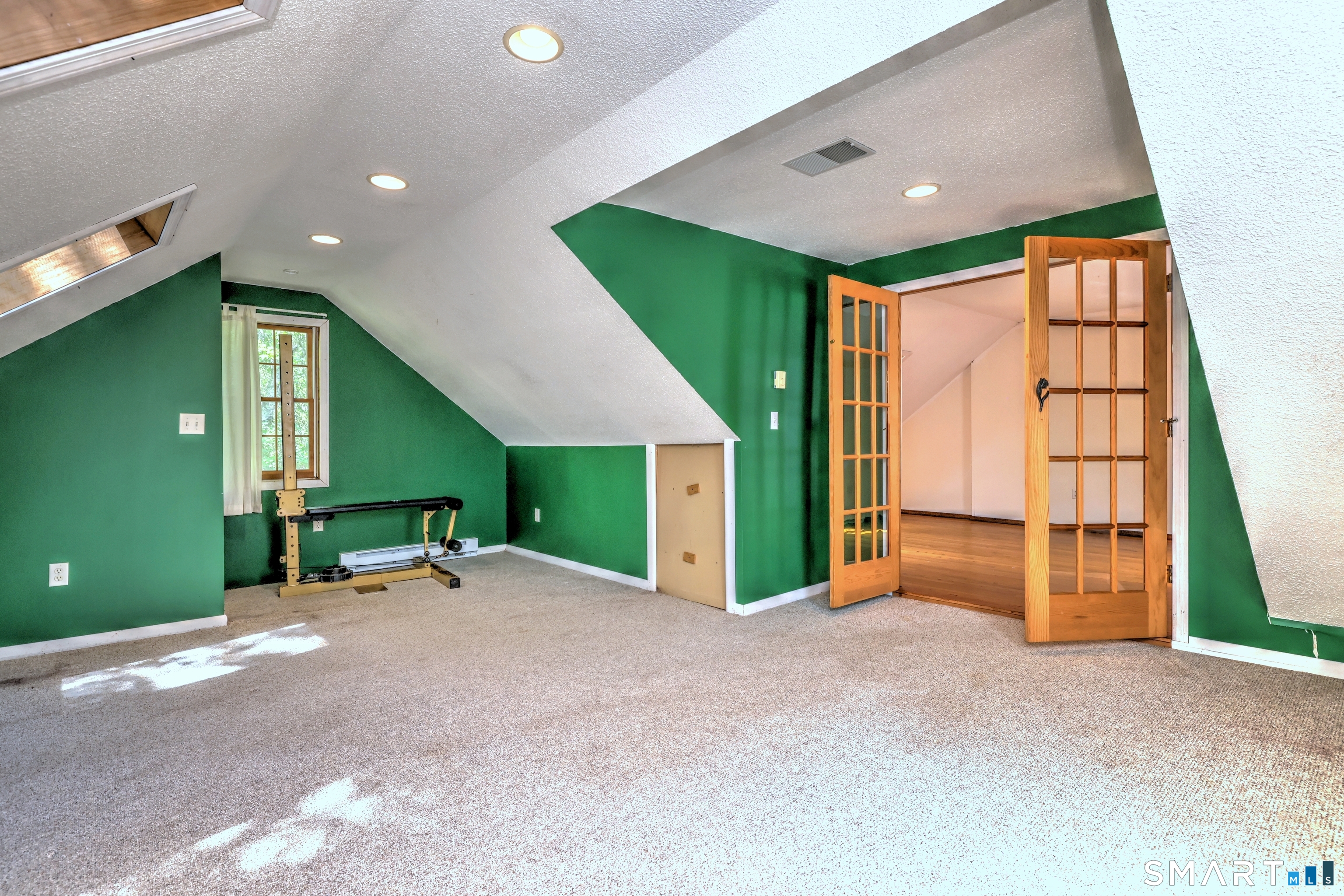22 East Woods Road Roxbury, CT 06783 - Photo 26 of 37 a view of an empty room with a fireplace and a window