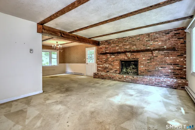 a view of empty room with a fireplace
