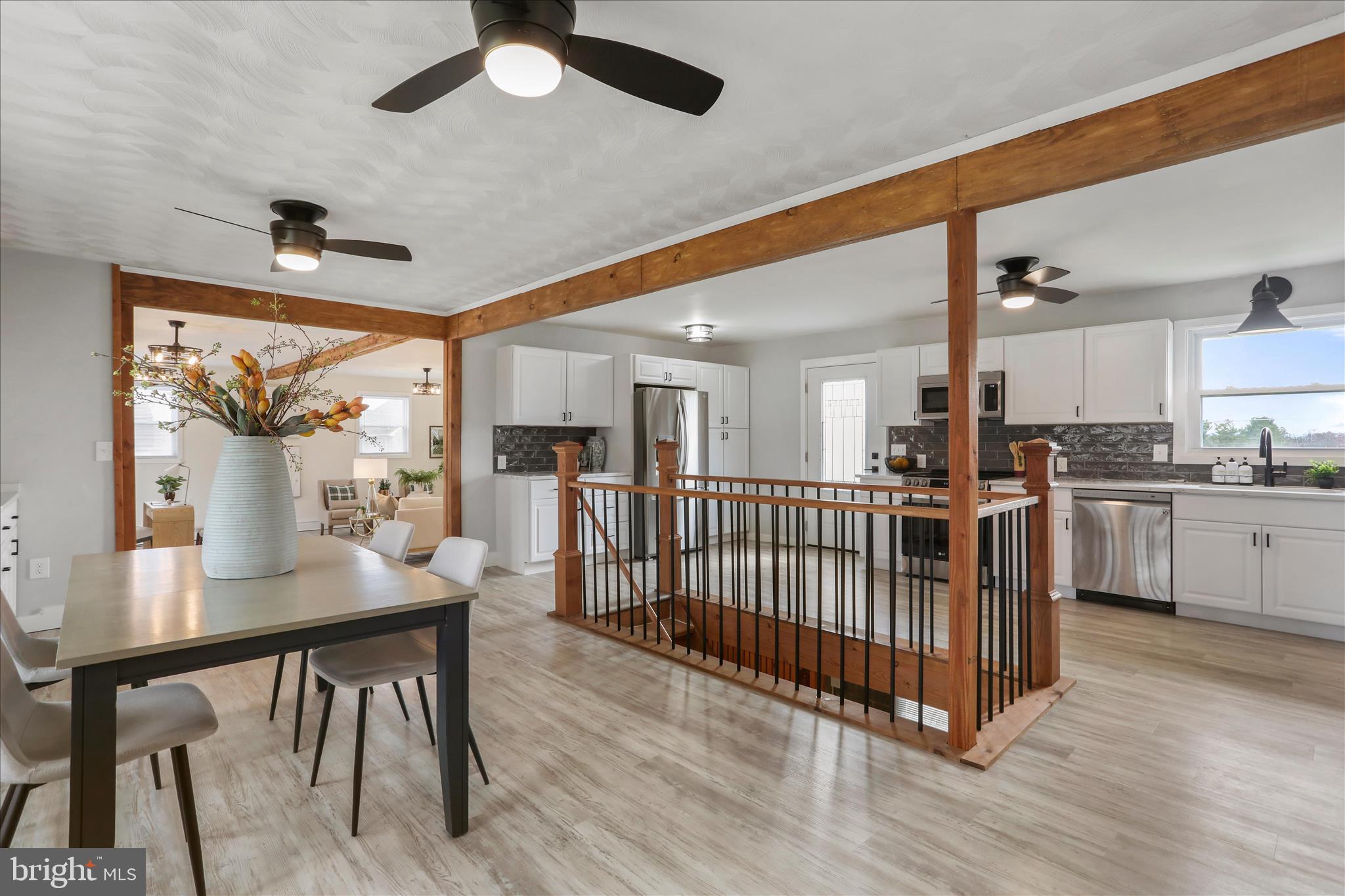 83 Dove Hill Drive Ranson, WV 25438 - Photo 12 of 71 a open kitchen with stainless steel appliances kitchen island granite countertop a table chairs and a refrigerator