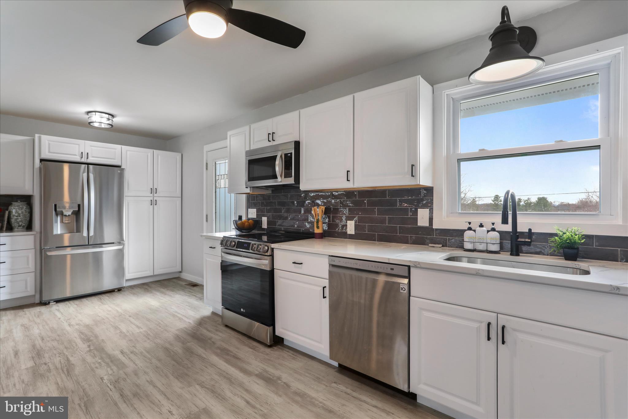 83 Dove Hill Drive Ranson, WV 25438 - Photo 16 of 71 a kitchen with a sink cabinets stainless steel appliances and a window