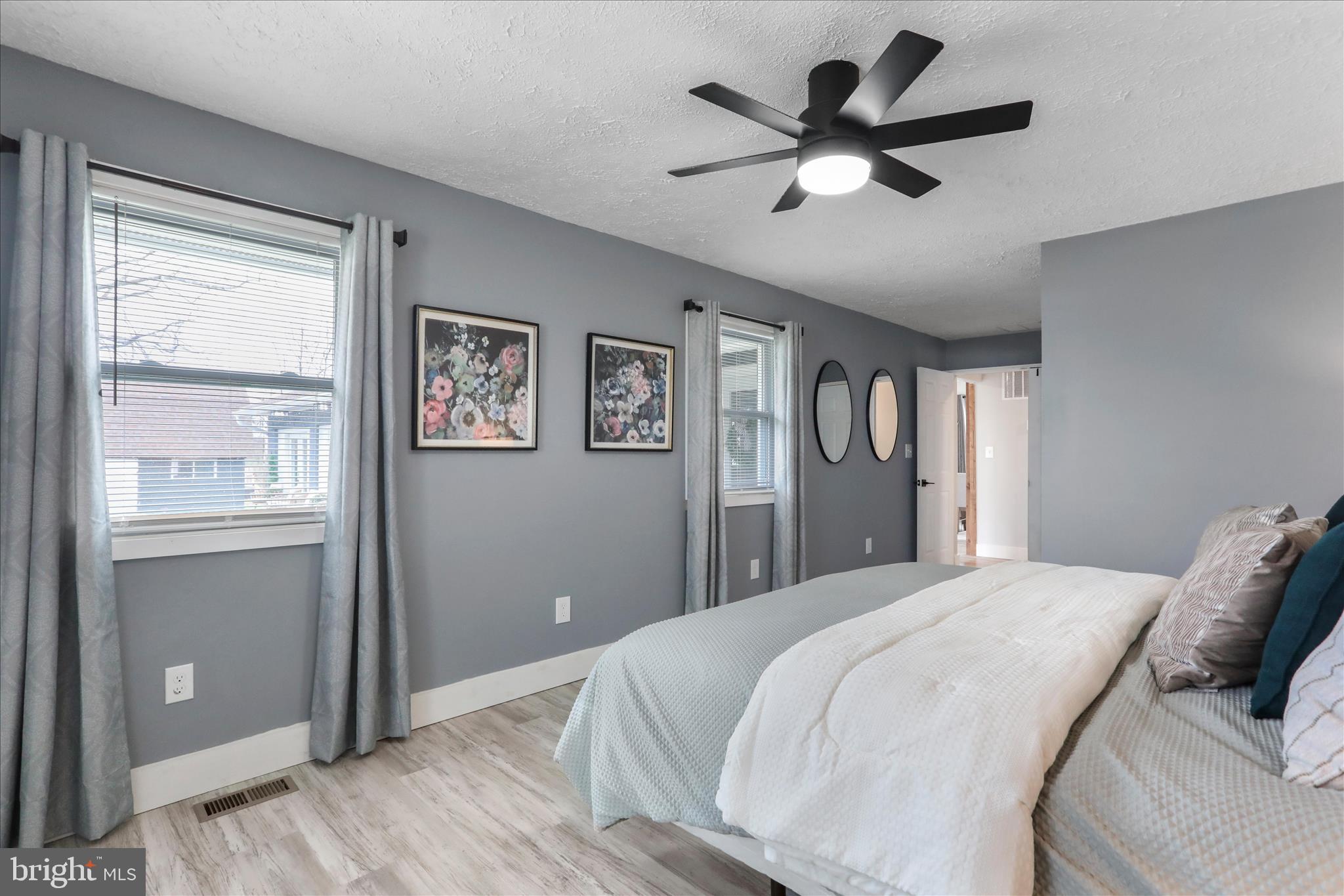 83 Dove Hill Drive Ranson, WV 25438 - Photo 26 of 71 a bedroom with a large bed chandelier and a window