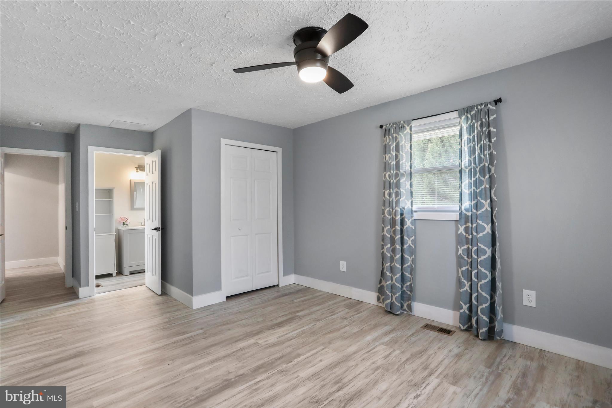 83 Dove Hill Drive Ranson, WV 25438 - Photo 32 of 71 wooden floor in an empty room with a window