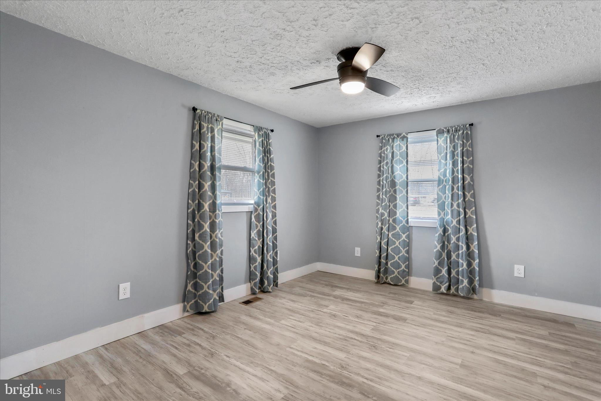 83 Dove Hill Drive Ranson, WV 25438 - Photo 33 of 71 wooden floor in an empty room with a window