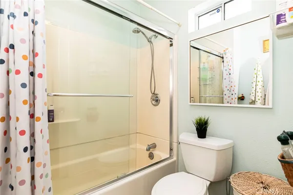 a bathroom with a toilet and a shower