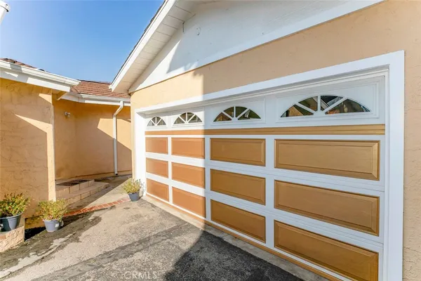 a view of an empty room with wooden floor and windows