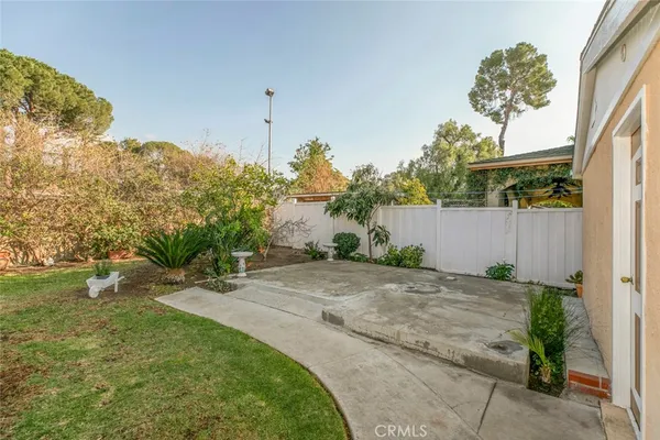 a backyard of a house with lots of green space and outdoor seating