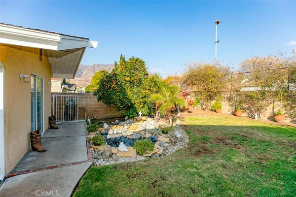a backyard of a house with table and chairs