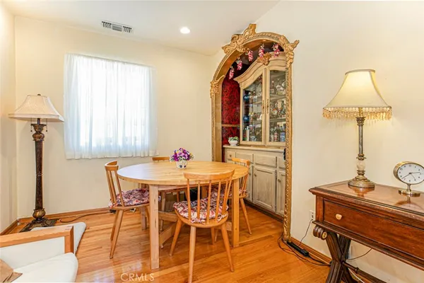 a view of a dining room with furniture and a window