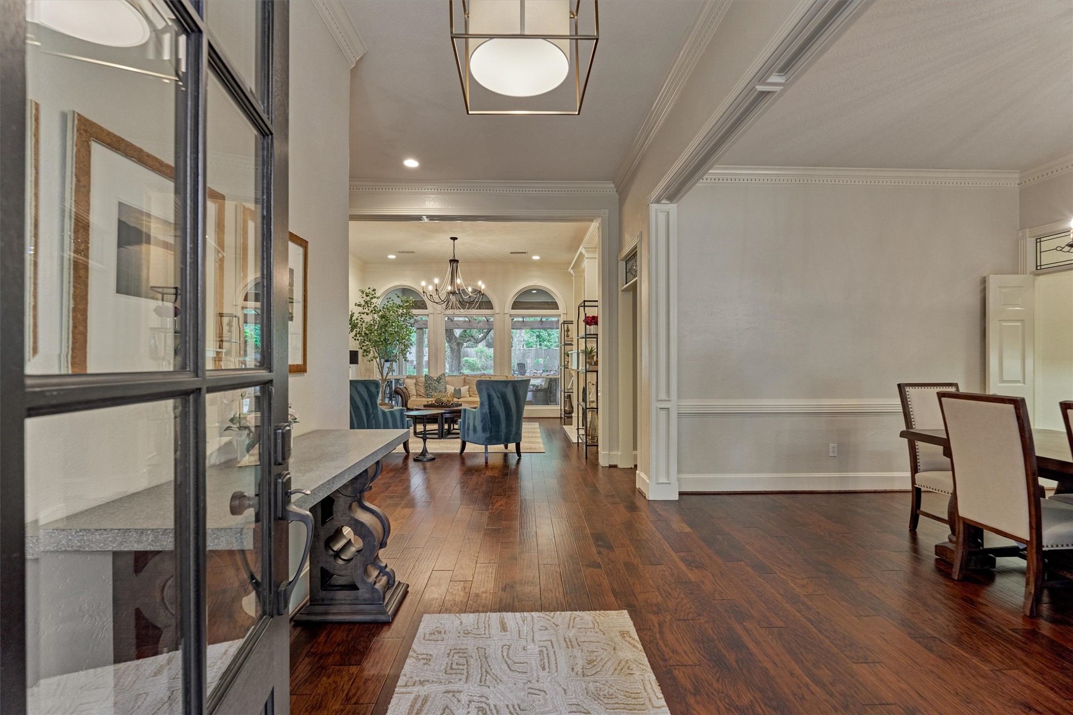 18 Treevine Court The Woodlands, TX 77381 - Photo 4 of 50 Step inside to discover notable architectural details, stunning sightlines, elegant moldings, and continuous wood flooring throughout.