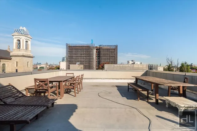 a view of a patio with dining table and chairs with a barbeque grill and plants