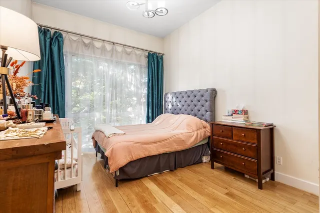 a bedroom with a bed and large windows